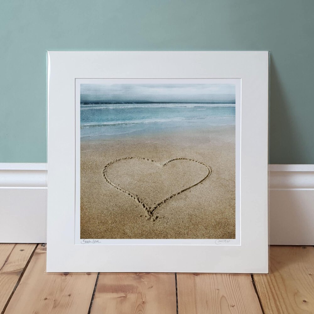 photo of beach love print in mount, leaning against wall