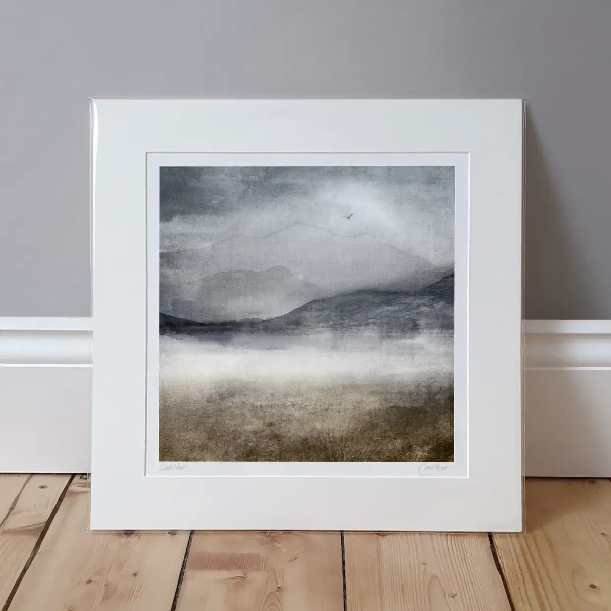 loch mist mounted print sitting on a wooden flor and leaning against a grey wall