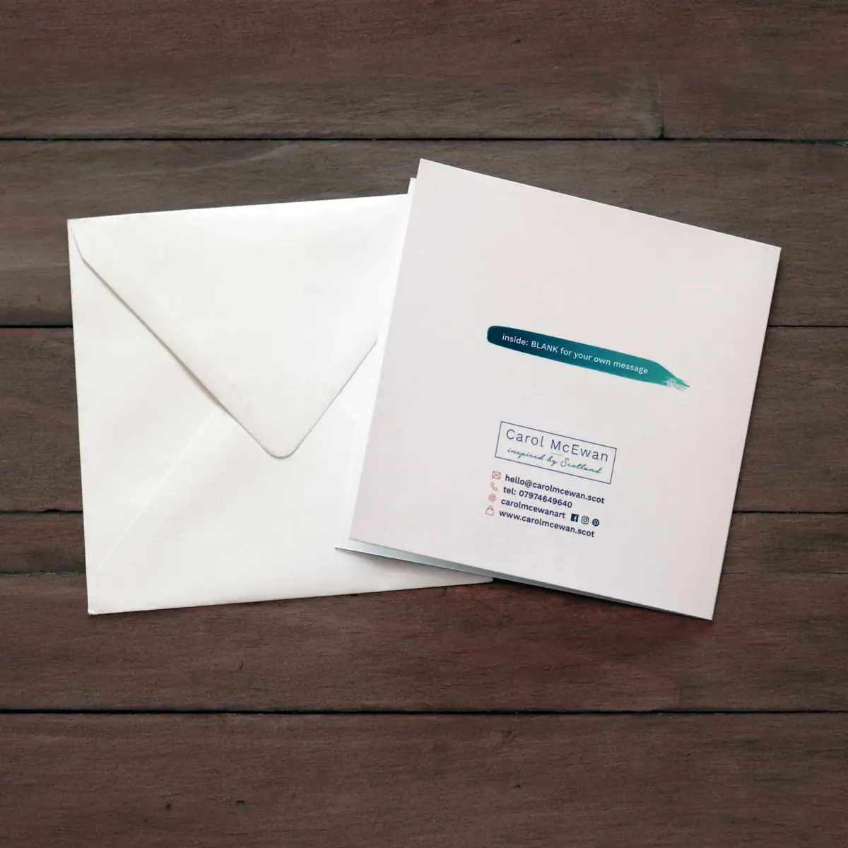 back of card and envelope on wooden table