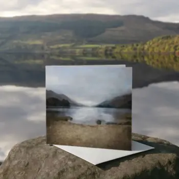 Scottish landscape greetings card of Glenfinnan, shown on a rock in front of a loch