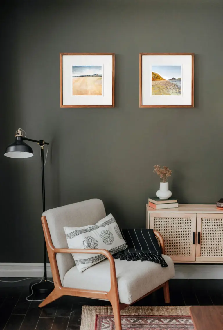 West Sands & Schiehallion art prints in frames in a living room with green walls. Artwork by Scottish artist Carol McEwan
